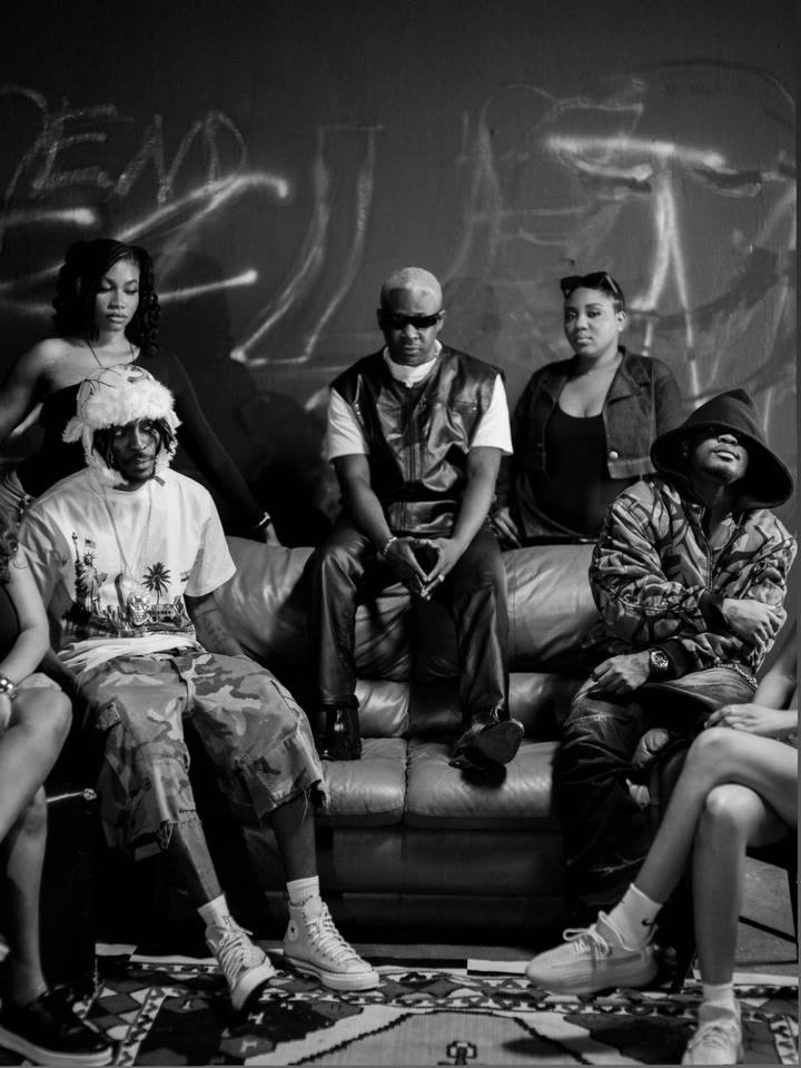 The DMY cast gathered on the couch, black and white